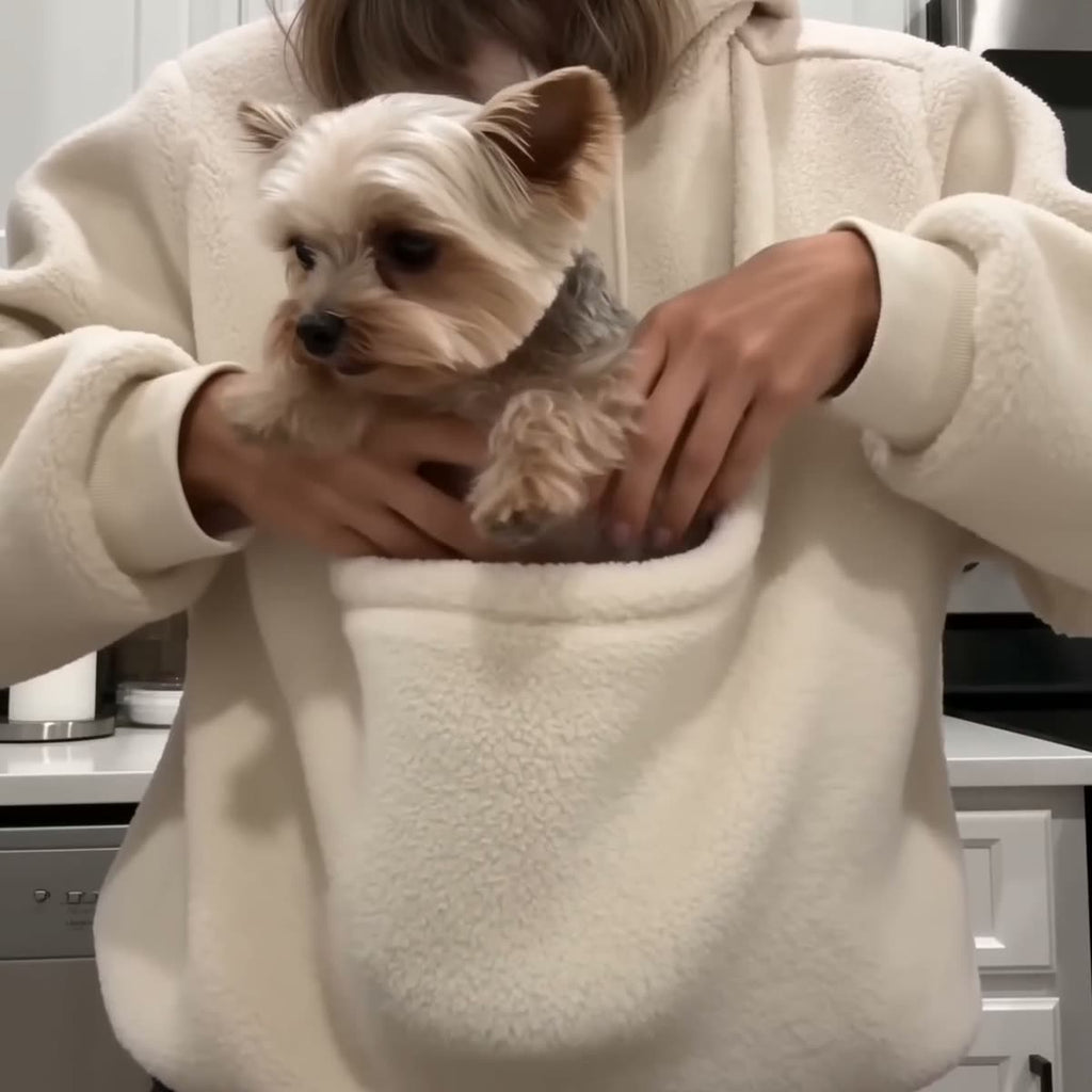 Dog settling into the sherpa-lined pouch in a kitchen
